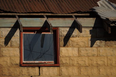 Low angle view of window on old building