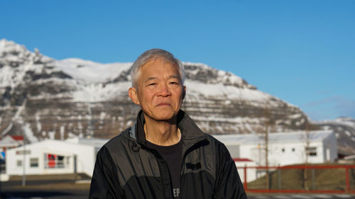 Portrait of man against mountain against sky