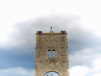 Low angle view of tower on building against sky