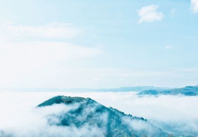 Scenic view of snowcapped mountains against blue sky