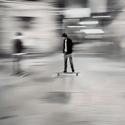 Blurred motion of people walking on street
