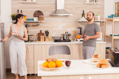 Man and woman preparing food in kitchen