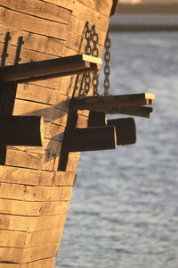 Close-up of cross on shore against sky