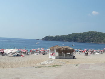 People on beach against clear sky