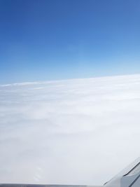 Scenic view of snow against blue sky