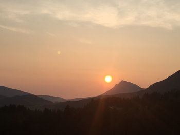 Scenic view of silhouette mountains against sky during sunset