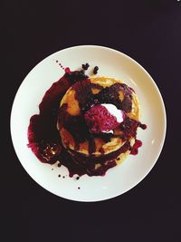 Close-up of pizza over black background