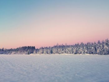 Scenic view of snow field against a glimt of pink sky