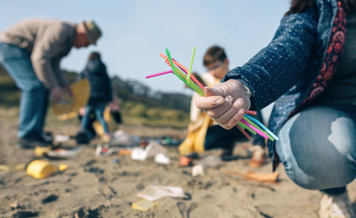 People holding hands on sand
