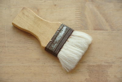 High angle view of paintbrush on wooden table