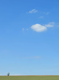 Scenic view of landscape against blue sky