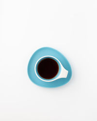 Directly above shot of black coffee on white background