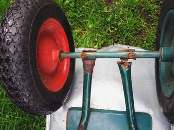 Broken rusty wheelbarrow damaged by metal corrosion