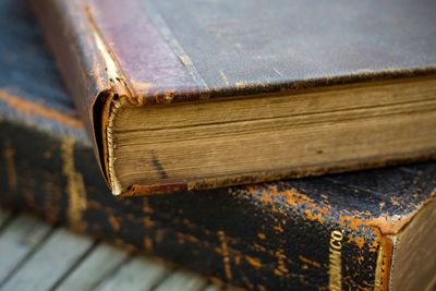 Close-up of old hardcover books on table