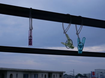 Low angle view of decoration hanging on bridge against sky