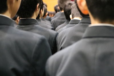 Rear view of men wearing suits