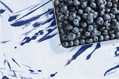 Blueberries or bilberries in tray on colored background, blue berries fruit , healthy eating