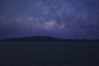 Scenic view of lake against star field at night