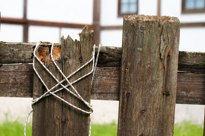 Detail of wooden fence with white rope binding
