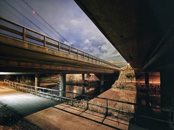 Bridge over river in city against sky