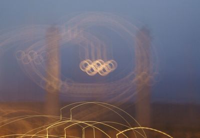 Digital composite image of light trails against sky at night