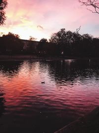 Scenic view of lake against sky at sunset