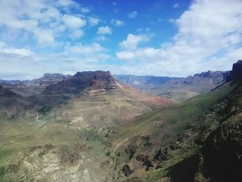 Scenic view of desert against blue sky