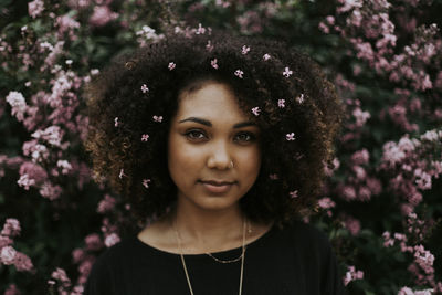 Portrait of beautiful woman with red flower