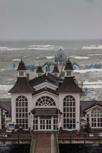 View of built structure by sea