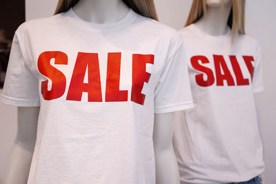 Sale text on t-shirt of mannequin at store