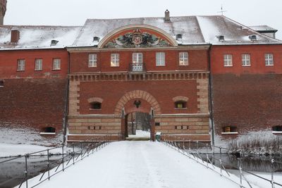 Snow covered built structure against sky