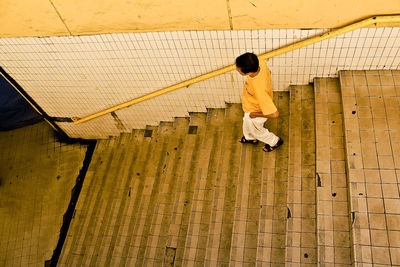 Full length of woman standing on railing