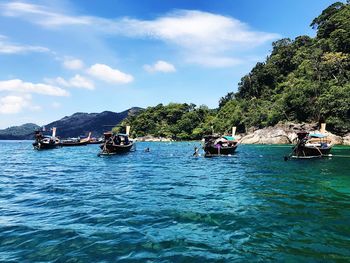 Boats in sea against sky