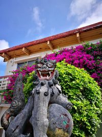 Low angle view of statues against sky