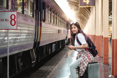 Portrait of smiling woman at railroad station