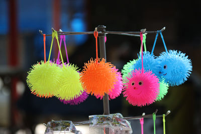 Close-up of multi colored candies hanging on display for sale