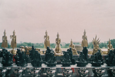 Panoramic view of statues and buildings against sky