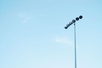 Stadium light pole in low angle with blue clear sky