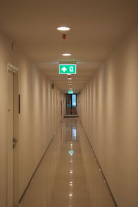 Empty corridor in illuminated building