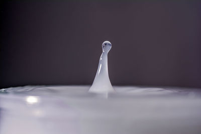Close-up of cake on table against black background