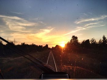 Car on road at sunset