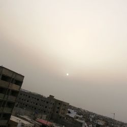 Low angle view of buildings against sky during sunset