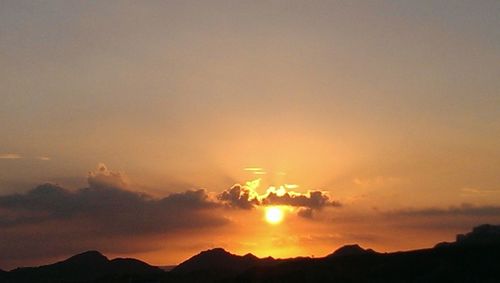 Scenic view of mountains against sky at sunset