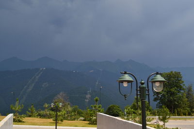 View of a lamp post against mountain range