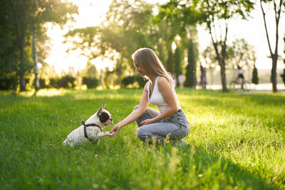 Woman with dog on field