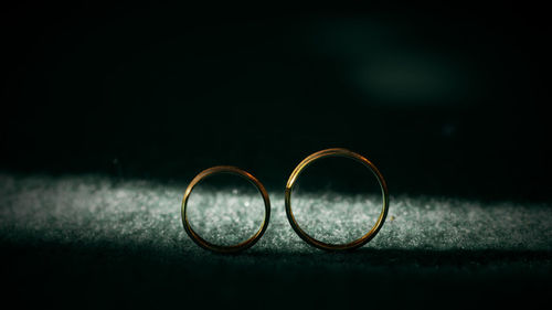 Close-up of wedding rings on eyeglasses