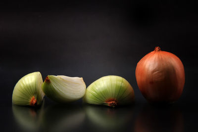 Close-up of fruits on table against black background