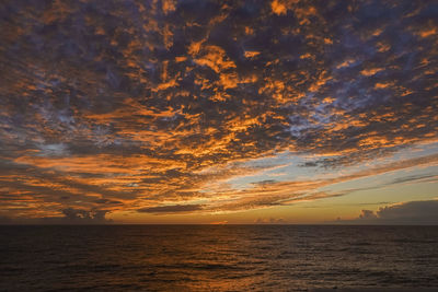 Scenic view of sea against orange sky