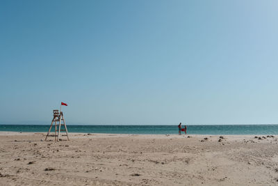 Scenic view of beach against clear sky