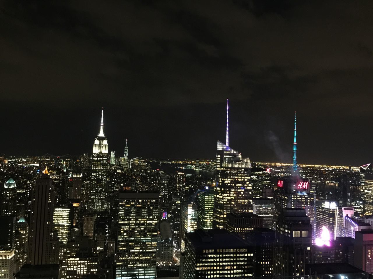 ILLUMINATED CITYSCAPE AGAINST SKY